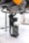 a man wearing a mask is working under a car